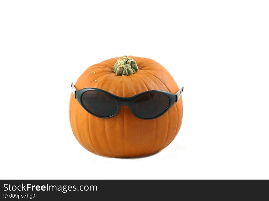 Whole large pumpkin dressed  with his  dark glasses. Whole large pumpkin dressed  with his  dark glasses