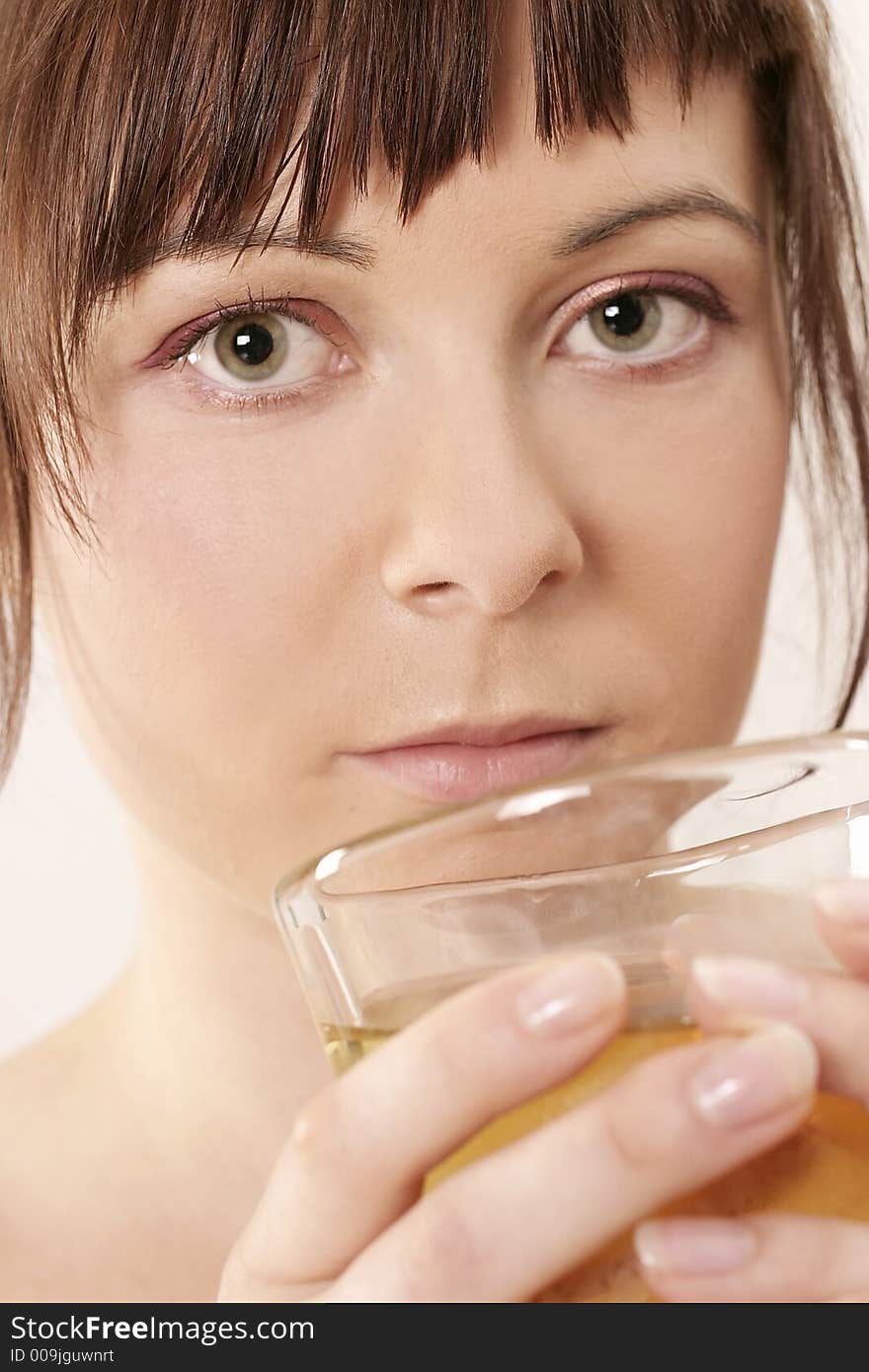 Young girl, woman drinking from a glass -close up. Young girl, woman drinking from a glass -close up