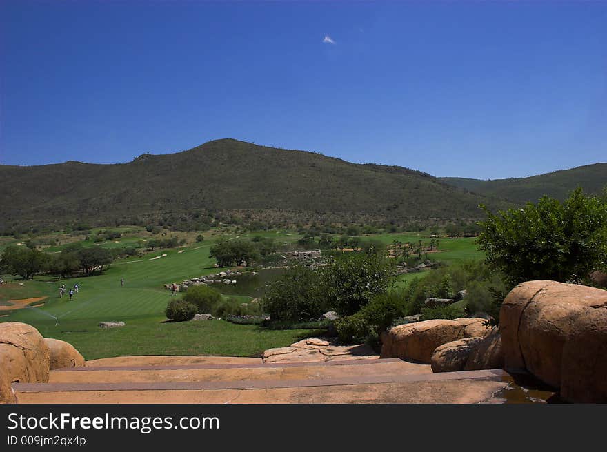 View from clubhouse over ninth fairway with golfers approaching