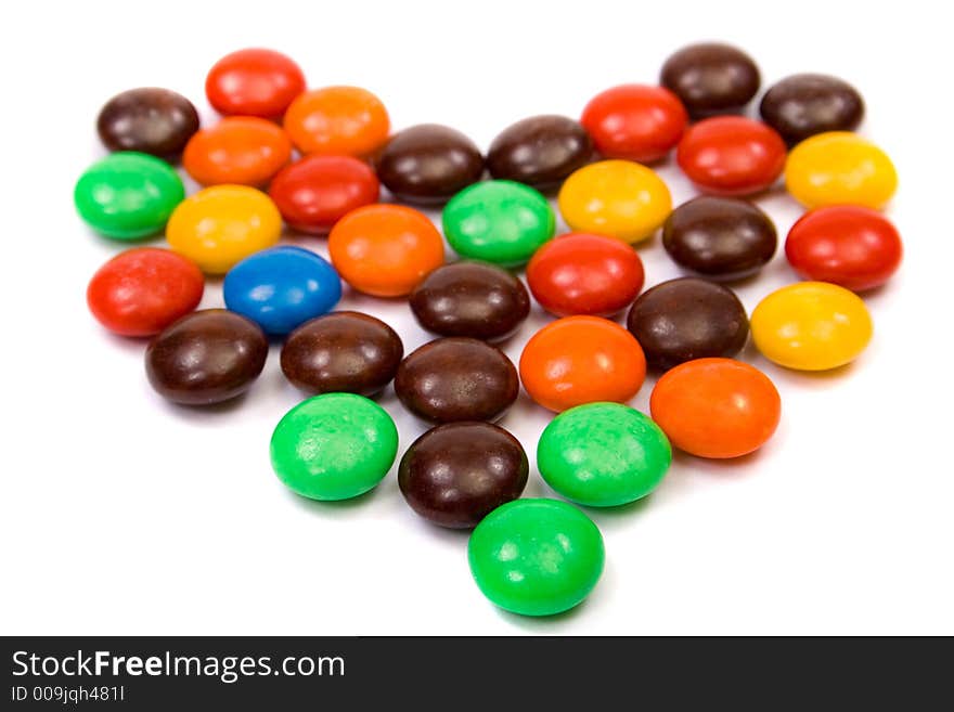 Colorful candies heart on white background