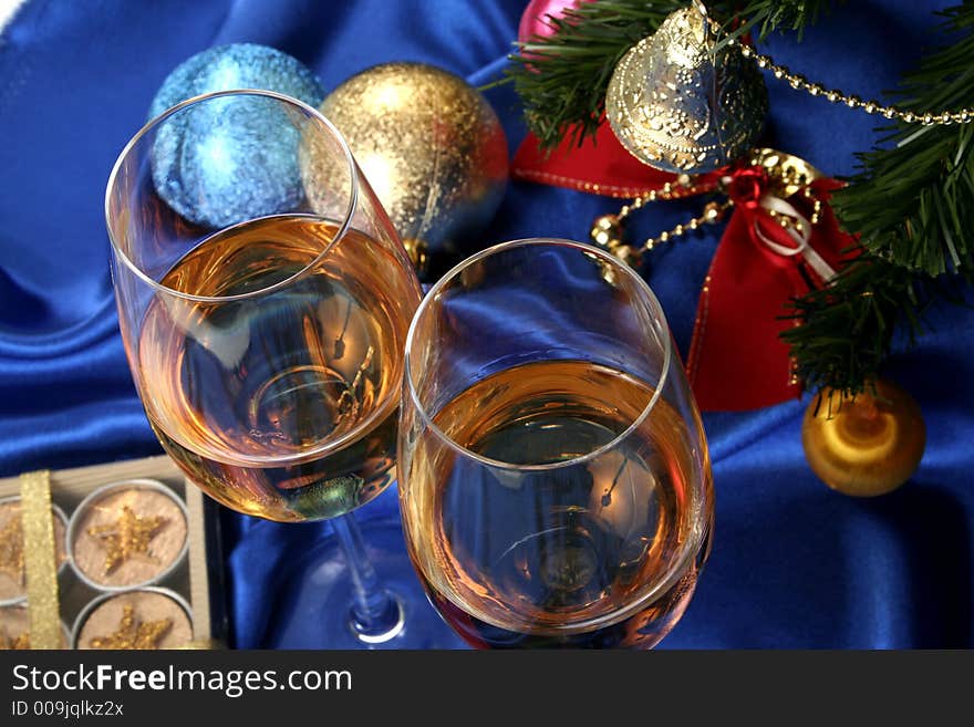 Glass of white wine on a beautiful christmas background with a New Year tree