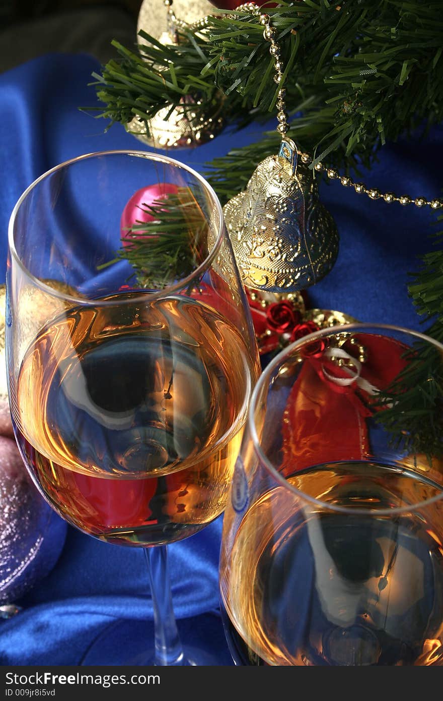 Glass of white wine on a beautiful christmas background with a New Year tree