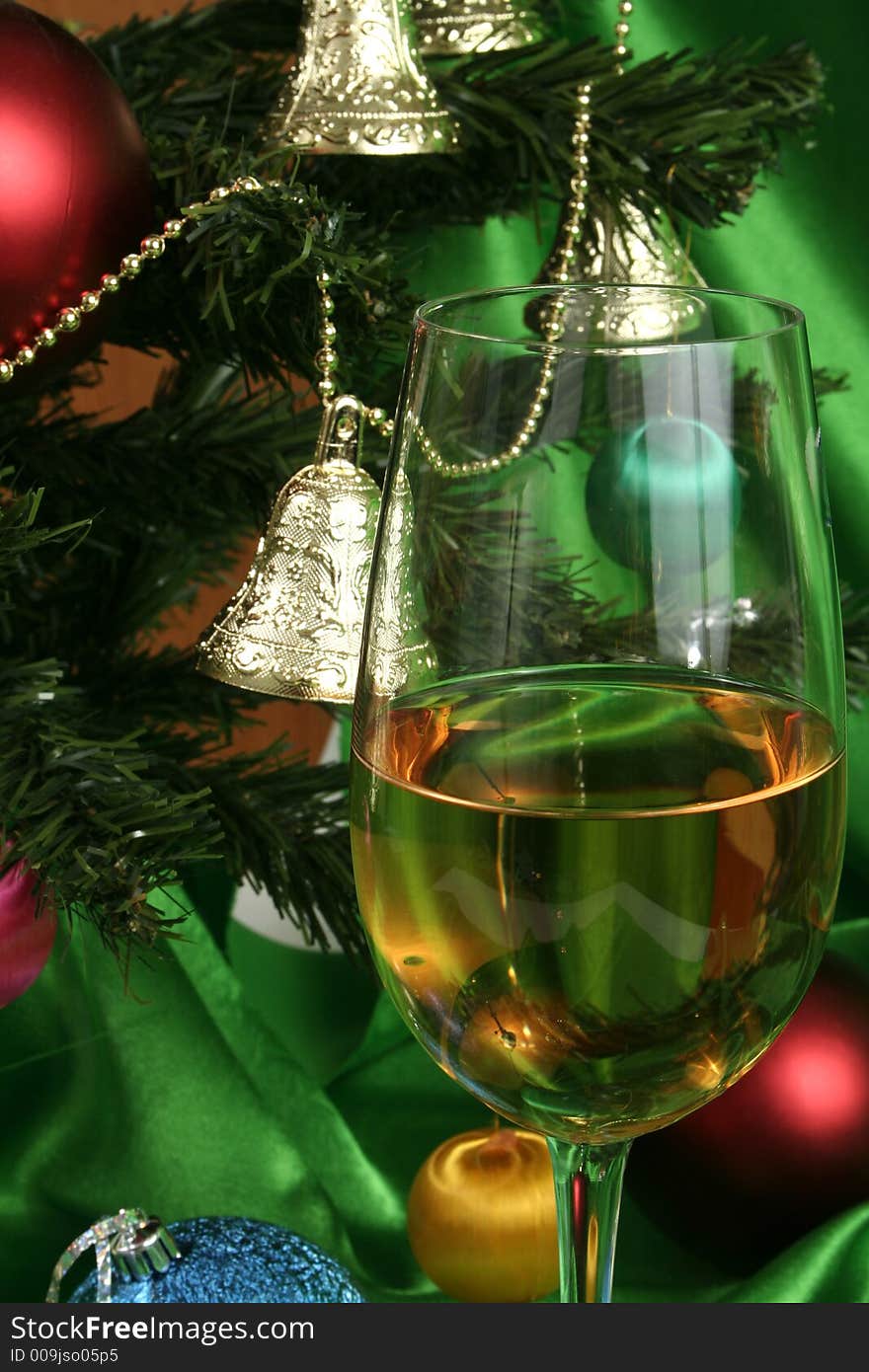 Glass of white wine on a beautiful christmas background with a New Year tree