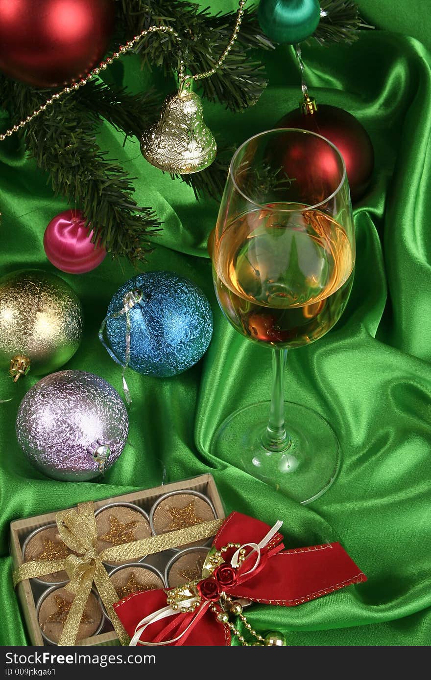 Glass of white wine on a beautiful christmas background with a New Year tree