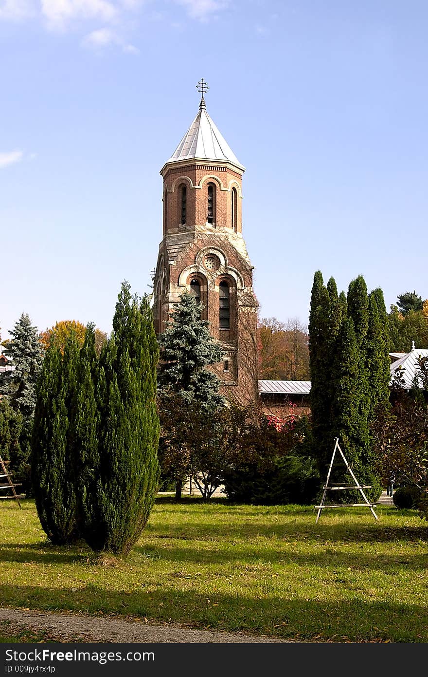 Brick church bell tower in Curtea de Arges Monastery park - Romania