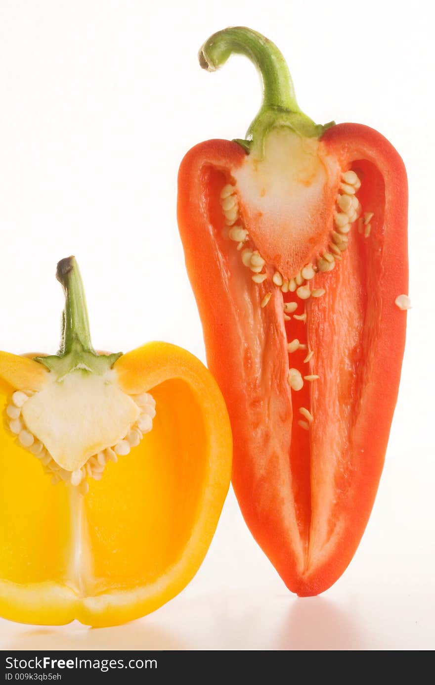 Fresh glossy tastefull peppers over white with slight reflection. Fresh glossy tastefull peppers over white with slight reflection