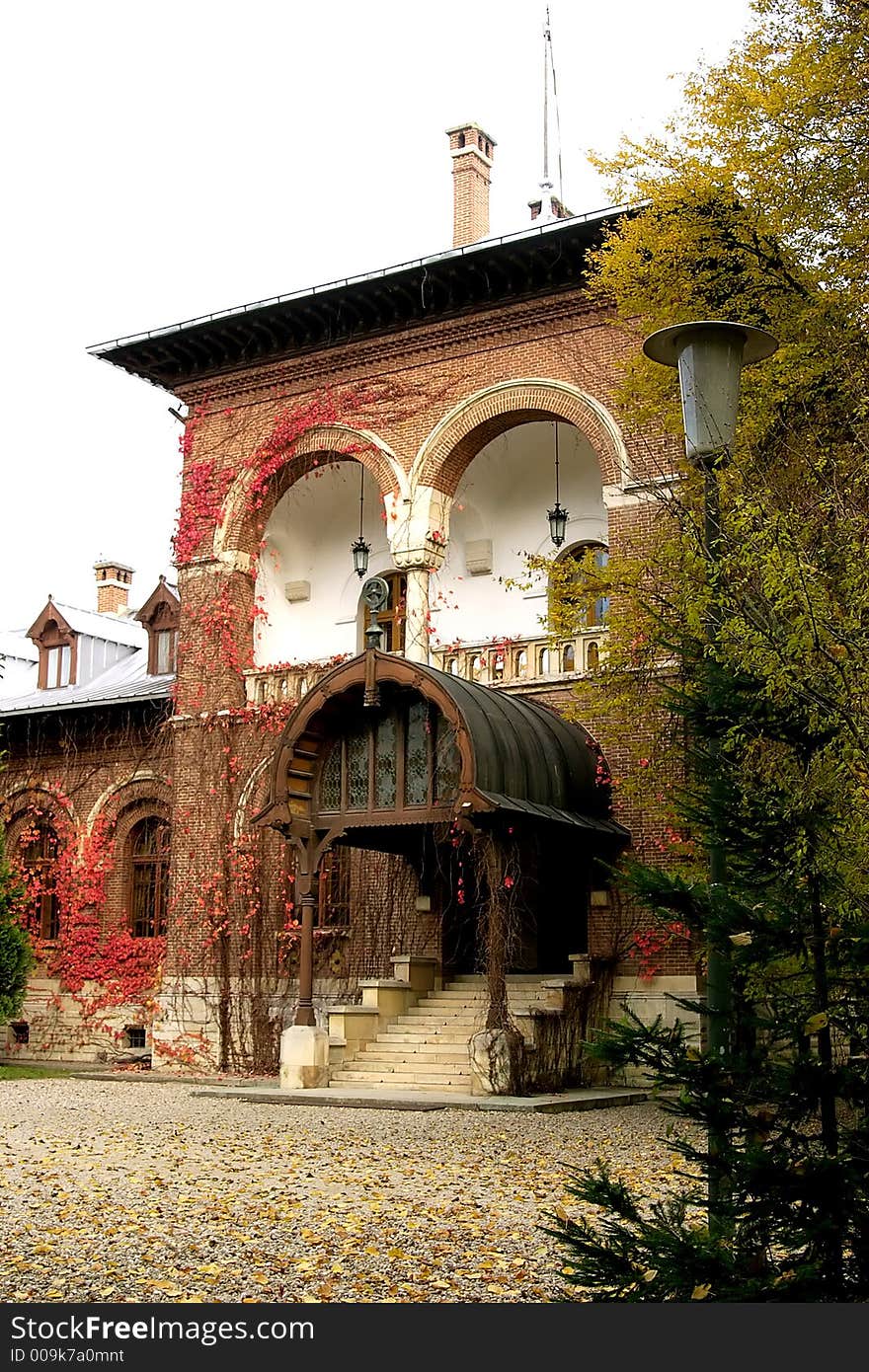 Dream old house with red ivy on the walls in Curtea de Arges Monastery park - Romania. An imppresive relgious monument finished in 7 january 1517 by Neagoe Basarab