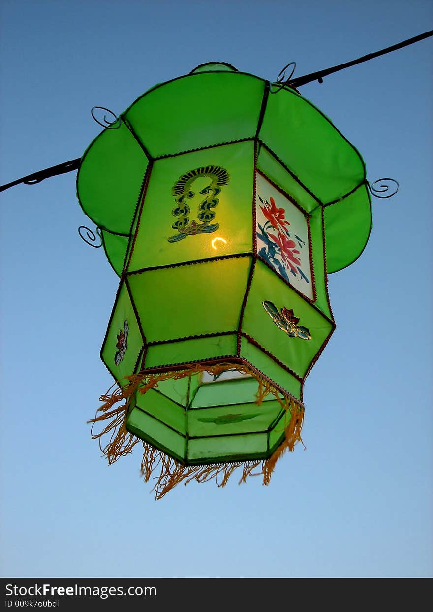 Cozy light of a green Chinese lantern