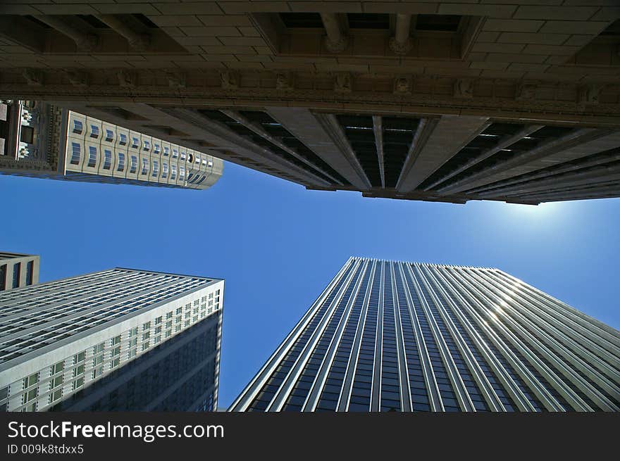 Shot looking upwards through a section of the financial district where there are many highrise office buildings. Shot looking upwards through a section of the financial district where there are many highrise office buildings