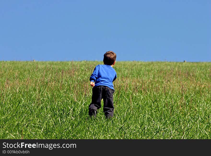 Boy Climbing A Hill