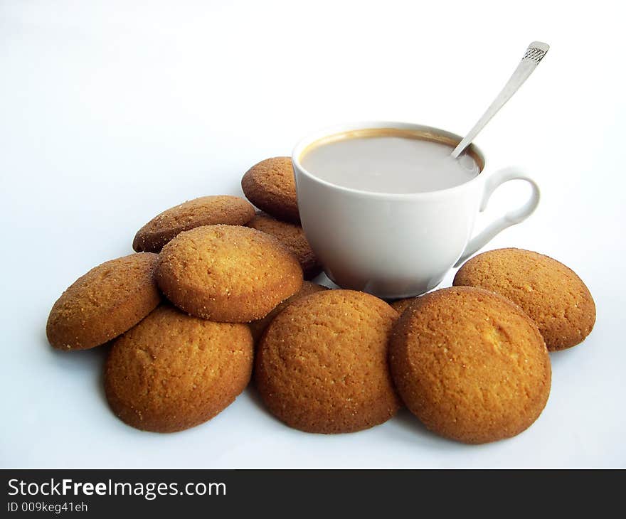 Mug of coffee on a white background with tasty cookies