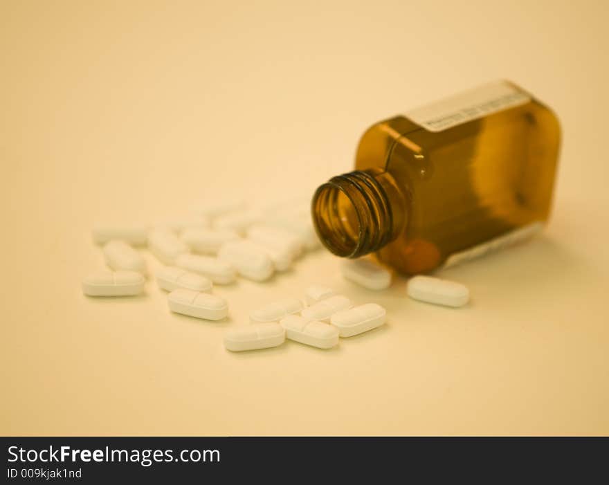 Bottle of pills in warm tones