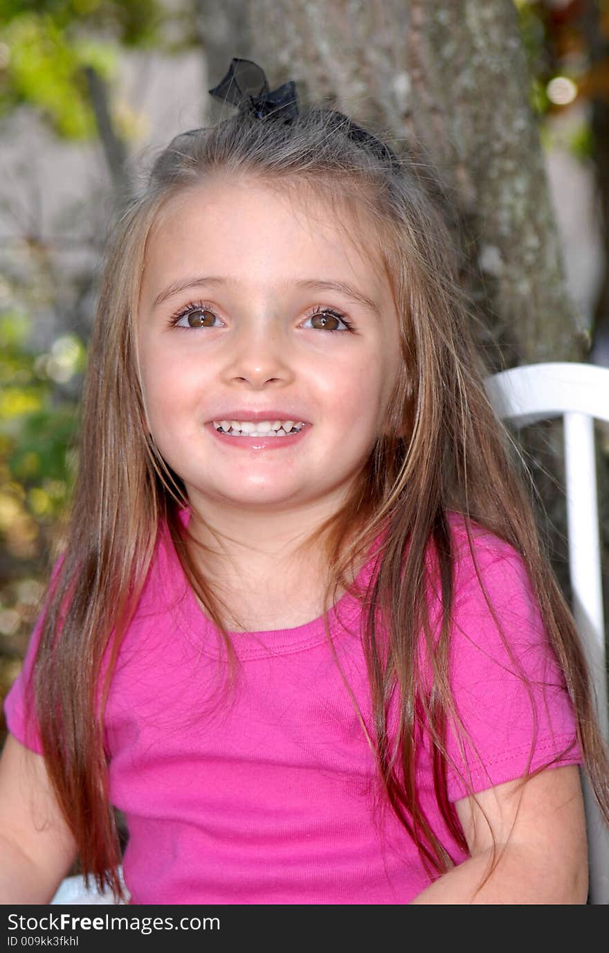 A pretty little brown haired, brown eyed girl smiling for her photos.  

She's in an outdoor setting and is wearing a hot pink shirt. A pretty little brown haired, brown eyed girl smiling for her photos.  

She's in an outdoor setting and is wearing a hot pink shirt.