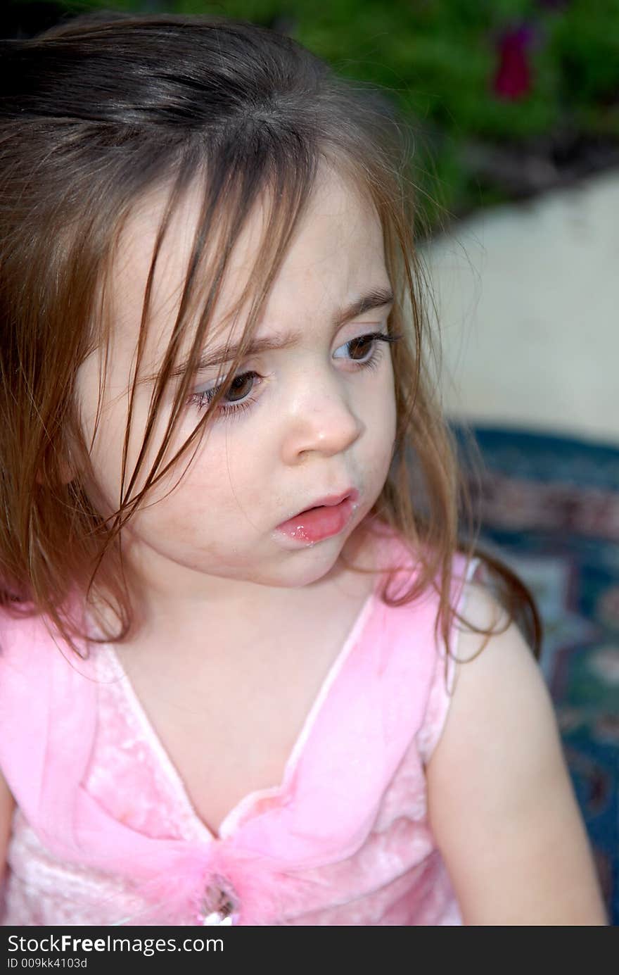 A brunette child looking very serious. A brunette child looking very serious.