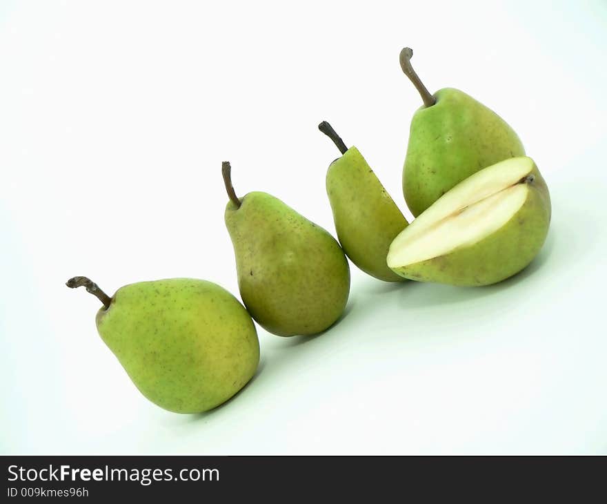 Whole and cut pears on white background