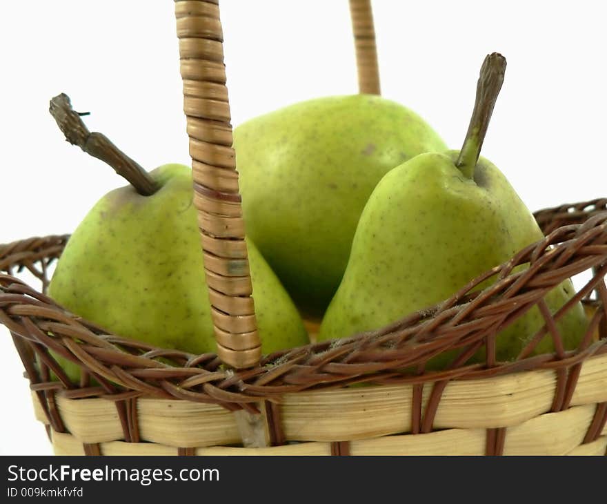 Whole and cut pears on white background