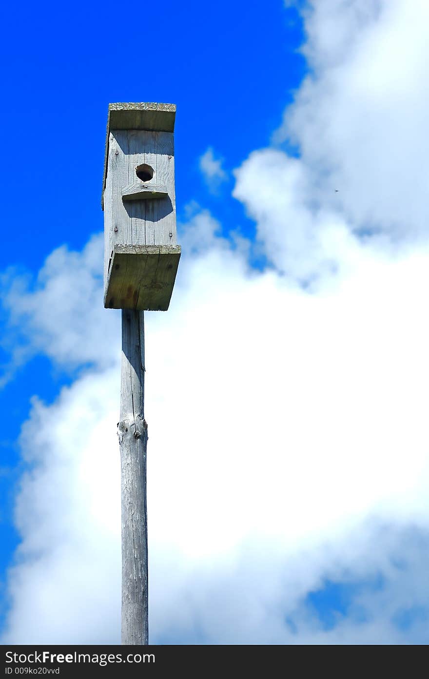 Nestling Box In The Cloudy Blue Sky