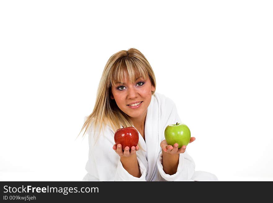 Young girl with two apples. Red and green. Focused on apples.