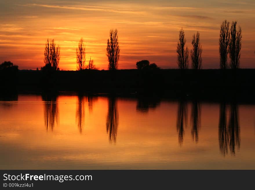 Fall sunnet in the air of november with trees and reflections. Fall sunnet in the air of november with trees and reflections