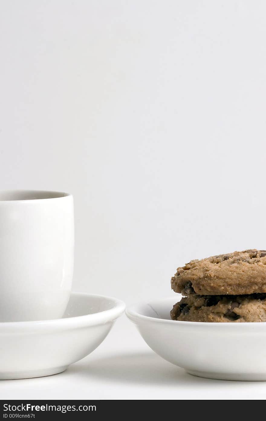 Coffee and Stack of Chocolate Chips cookies on white plate isolated on white background