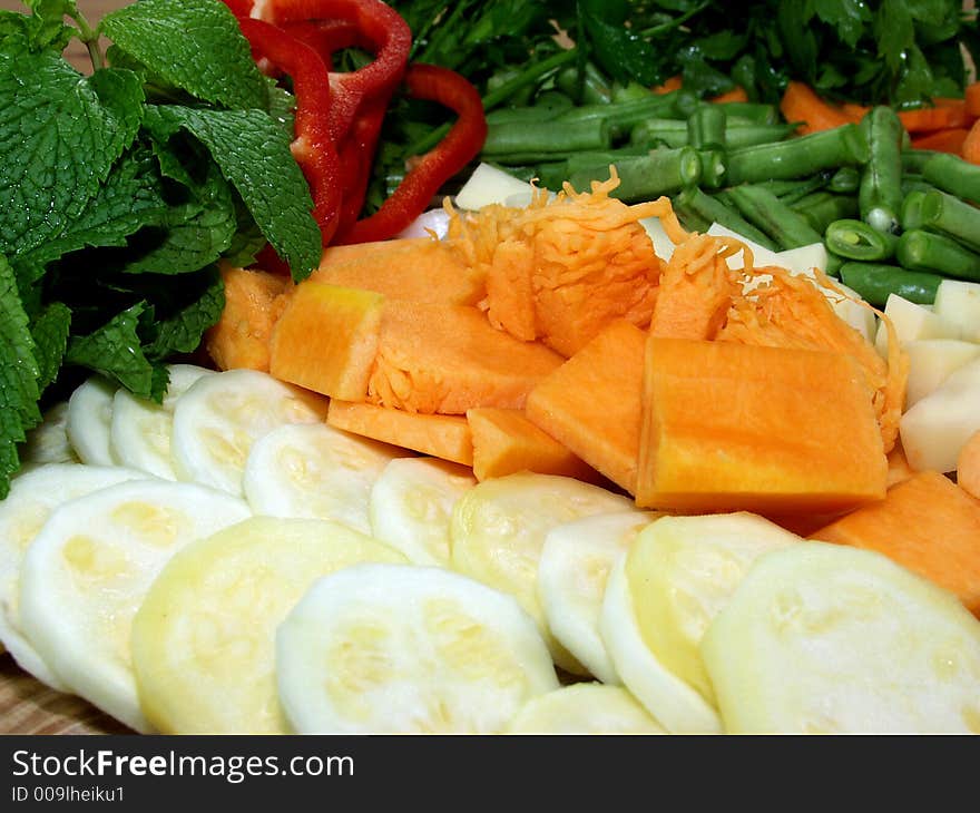 Fresh vegetables cutted on a wooden surface whit herbs