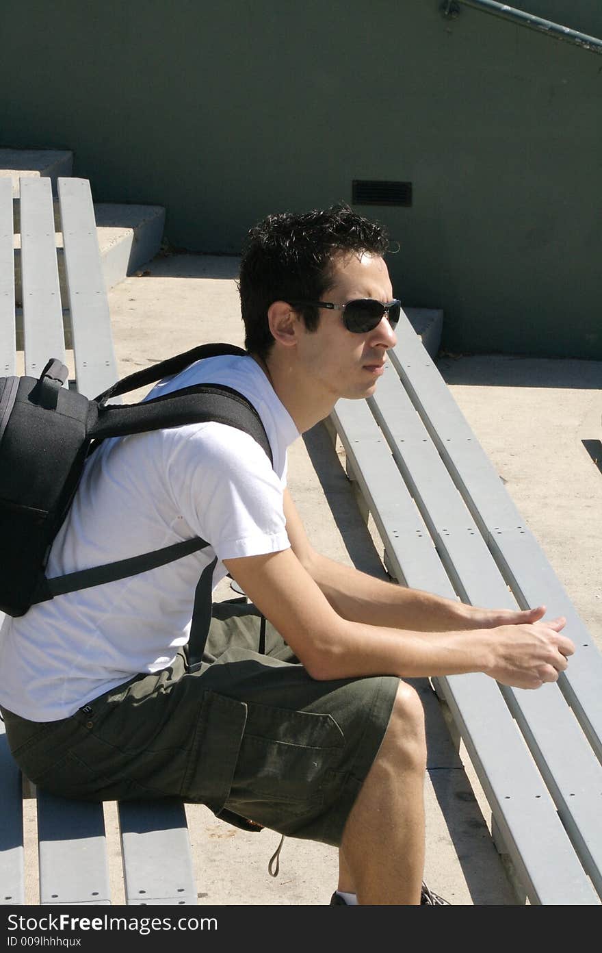 A young man sitting and waiting. A young man sitting and waiting