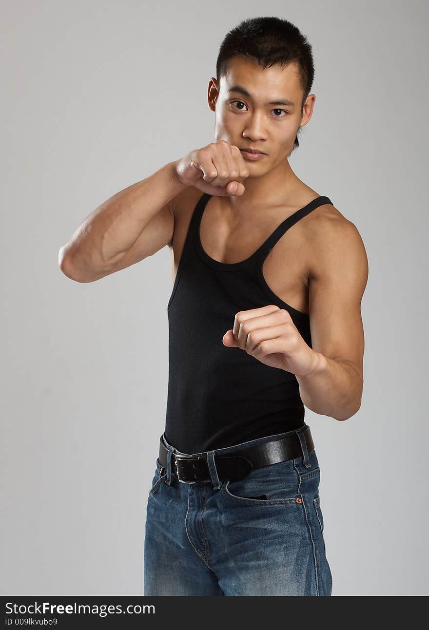 Great looking asian guy shot in studio - martial arts pose. Great looking asian guy shot in studio - martial arts pose