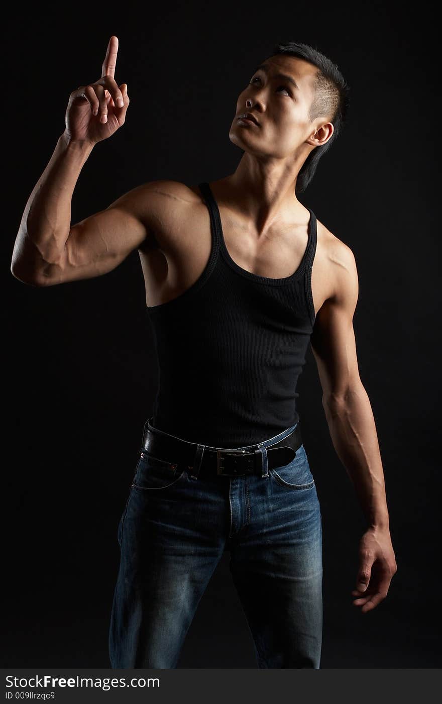 Great looking asian guy shot in studio - pointing upwards. Great looking asian guy shot in studio - pointing upwards