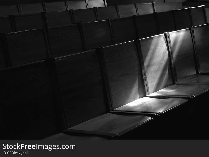 Black And White Image Of Rows Of Church Pews With Stream Of Ligh