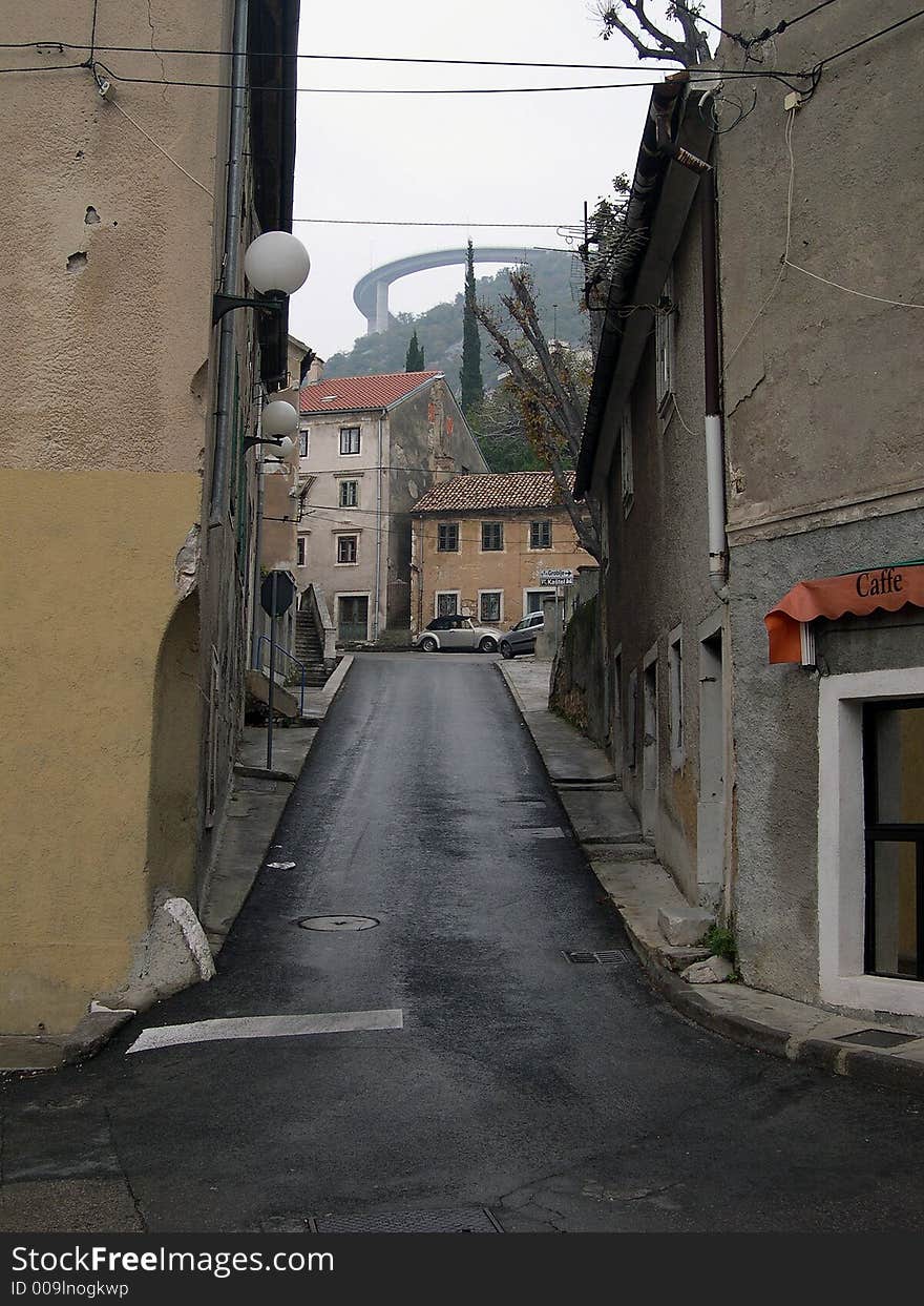 Small street with viaduct over small town, Croatia, Europe