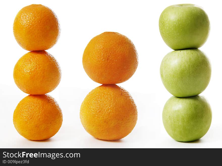 Stack of apples and oranges isolated on white background