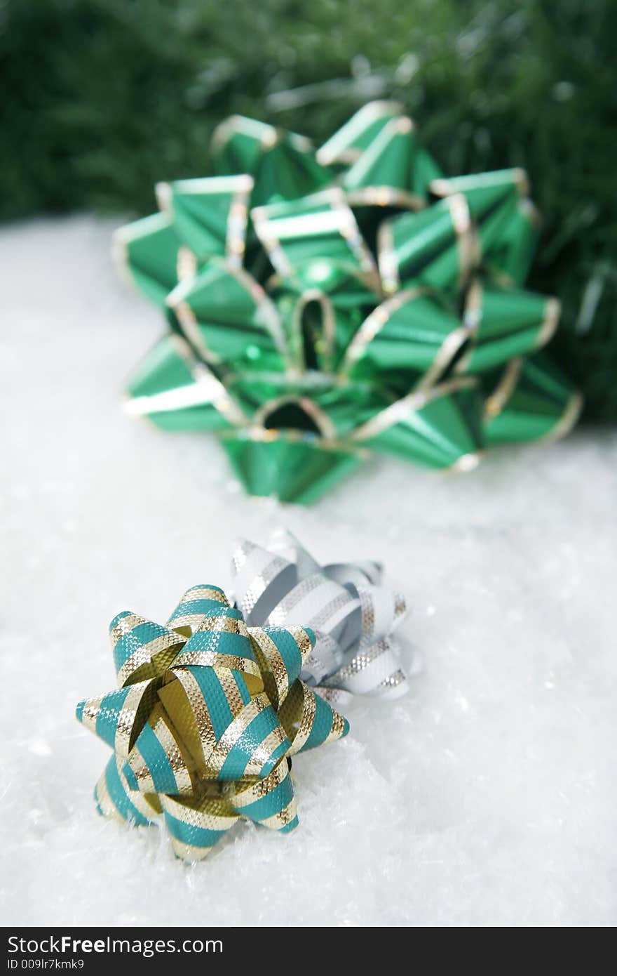 Christmas decorating bow in pile of snowflakes. Christmas decorating bow in pile of snowflakes