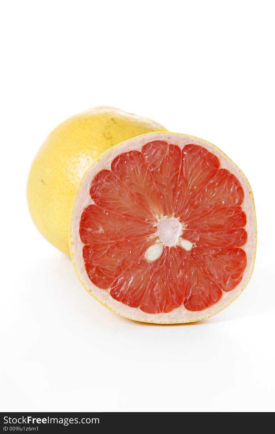 Isolated pink grapefruits, sliced piece in focus