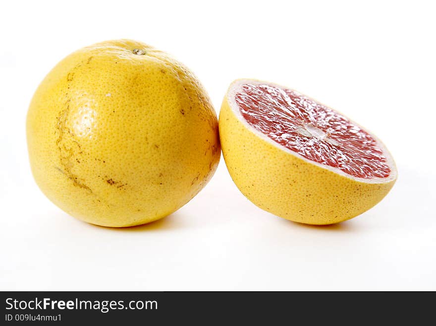 Isolated pink grapefruits, sliced piece in focus