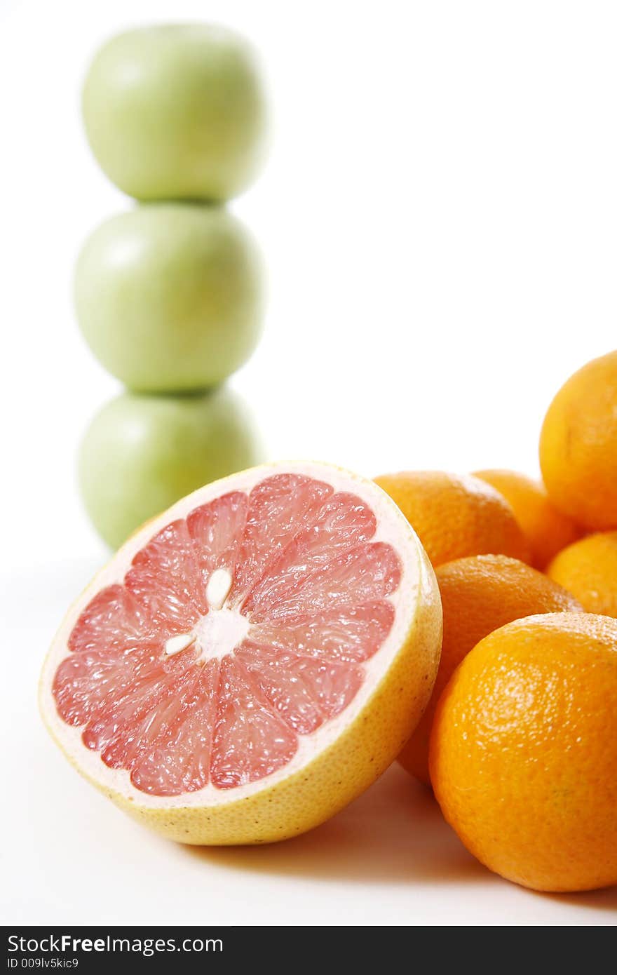 Assorted fruit over white - Apple stack in the background