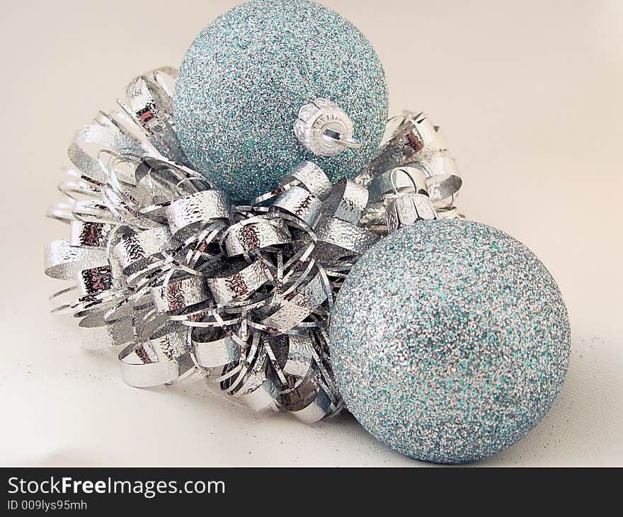 Various colored Xmas ornaments against a snowy background. Various colored Xmas ornaments against a snowy background