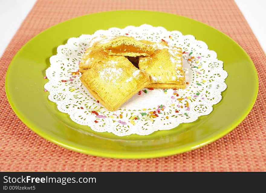 Marmelade filled baked sweet squares with powdered sugar on top. Marmelade filled baked sweet squares with powdered sugar on top