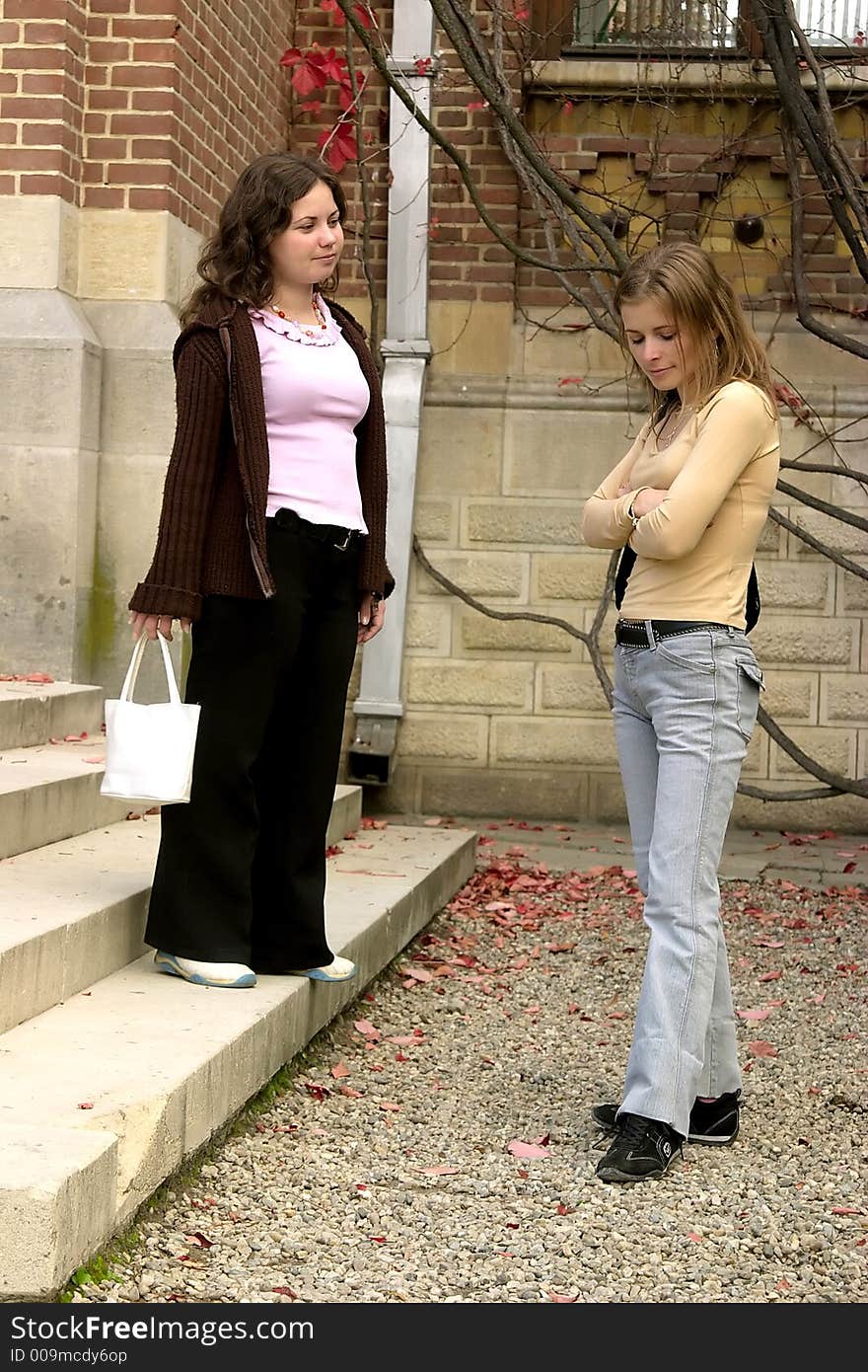 Two young women talking outdoor. Two young women talking outdoor