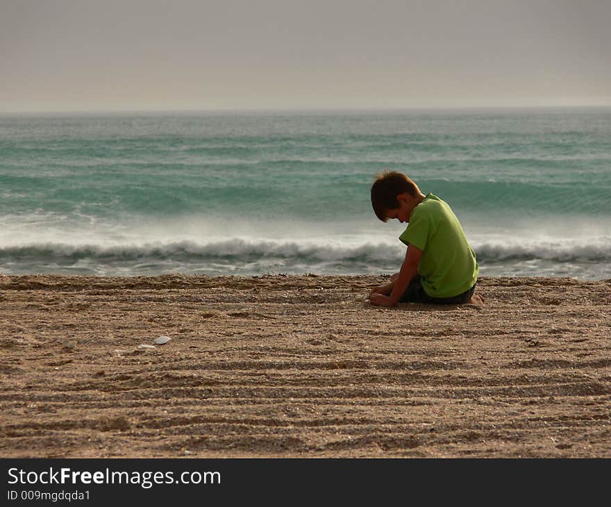 A boy plays on the beach. A boy plays on the beach