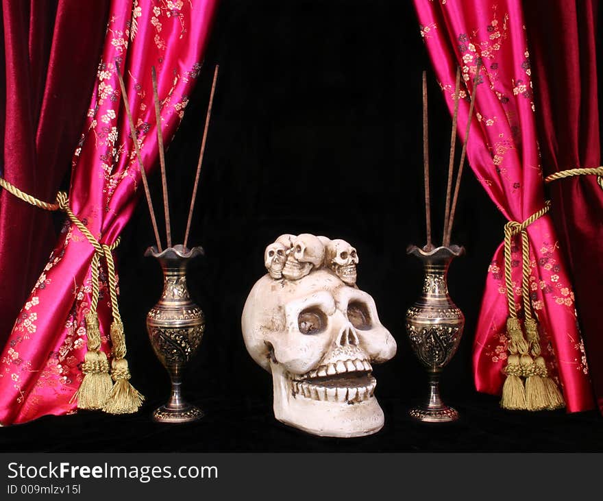 Skull with Incense on Black and Red Background