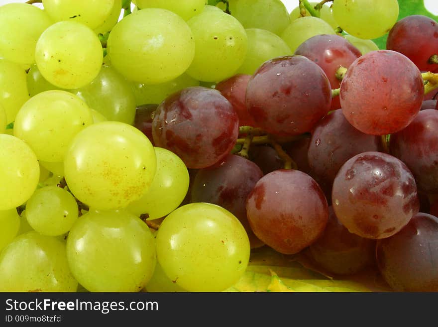 Seasonal grapes with leaves on white. Seasonal grapes with leaves on white