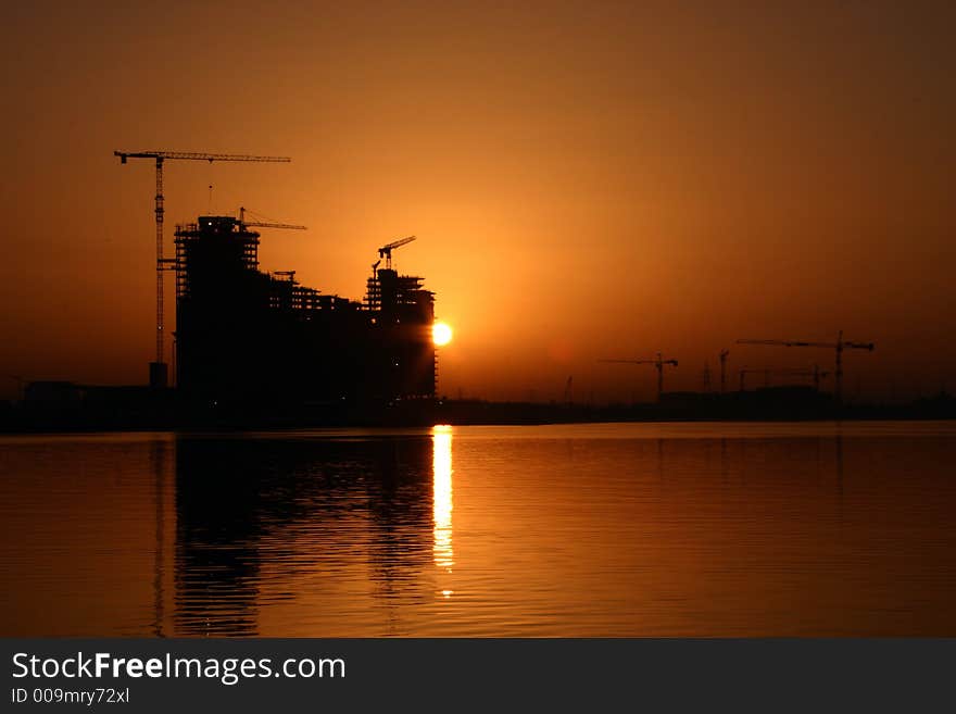 A construction site near a creek side with a good sunsire view. A construction site near a creek side with a good sunsire view