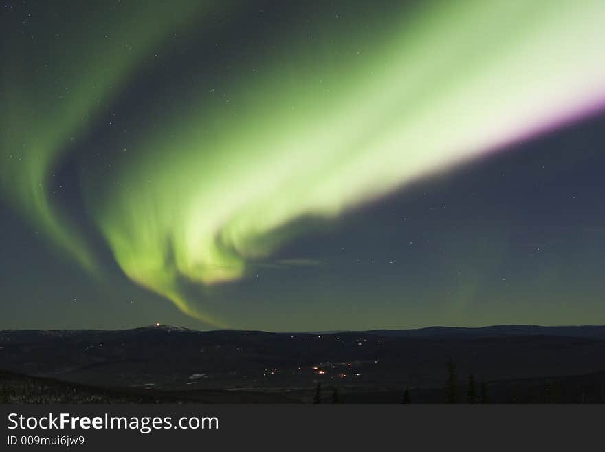 Colorful band of northern lights in the night sky. Colorful band of northern lights in the night sky