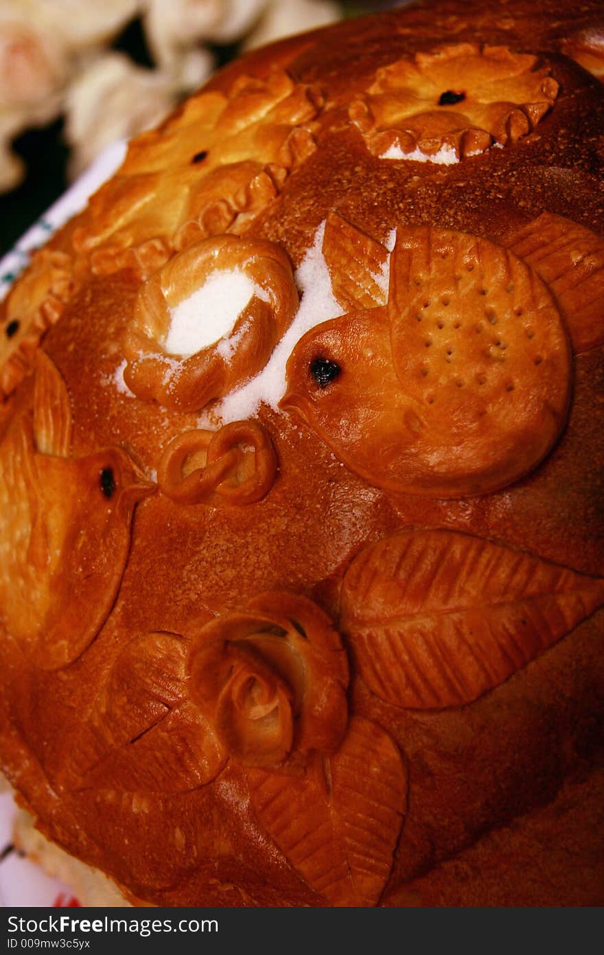 Russian wedding tradition. Parents welcome newly married couple with home-made bred and salt. Bride and bridegroom bite off piece of bread. The biggest piece - simbol of leadership in relationships. After they feed each other, dipping slices into salt. So they show sharing sorrows and joys. Russian wedding tradition. Parents welcome newly married couple with home-made bred and salt. Bride and bridegroom bite off piece of bread. The biggest piece - simbol of leadership in relationships. After they feed each other, dipping slices into salt. So they show sharing sorrows and joys.