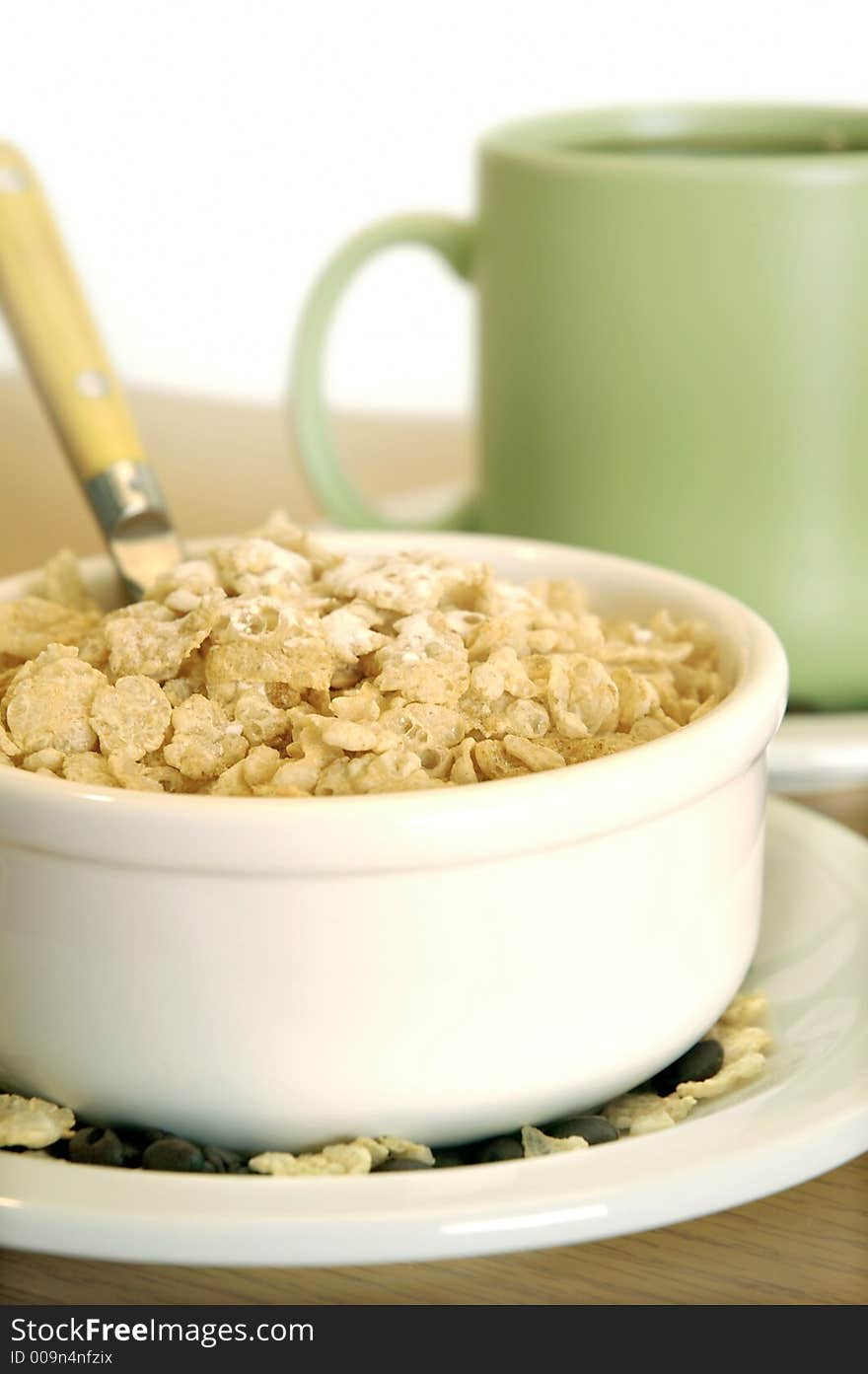 Bowl of cereal and coffee mug on table. Bowl of cereal and coffee mug on table