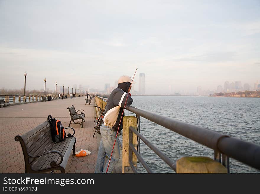 Lonely Man Fishing In Sunset