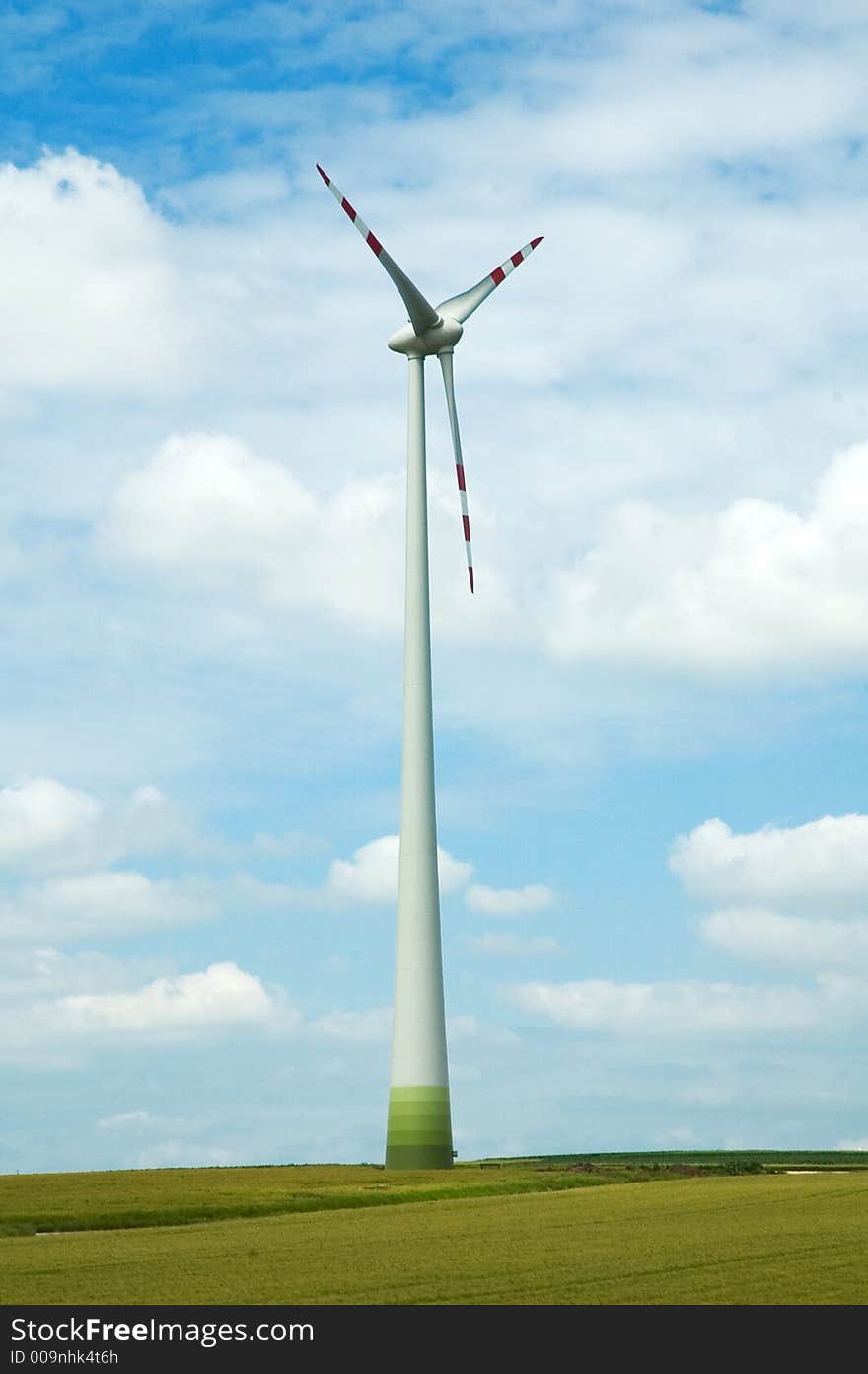 Large energy windmill standing in green summer field. Large energy windmill standing in green summer field