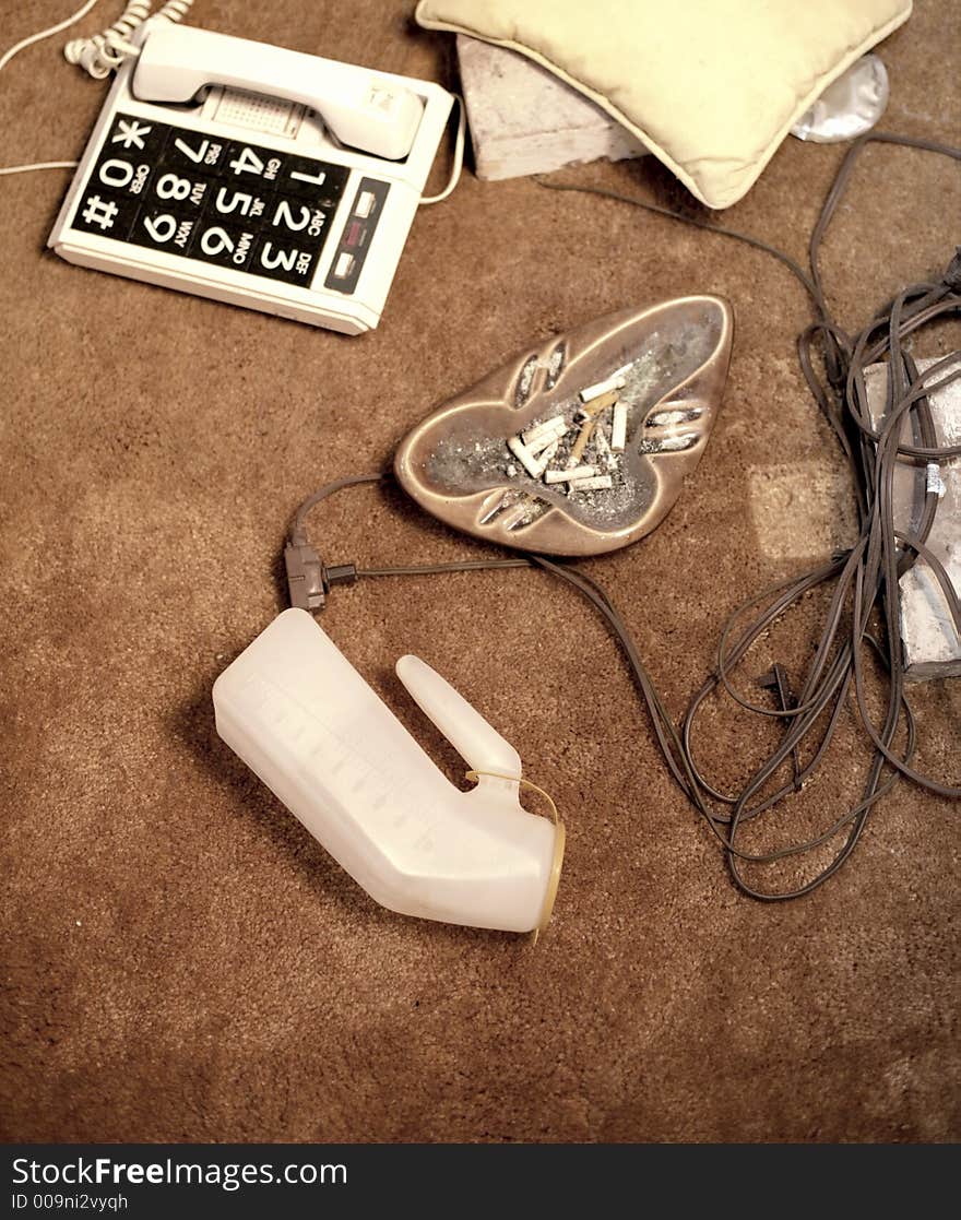 Ashtray, phone, and urine jug on floor. Ashtray, phone, and urine jug on floor.