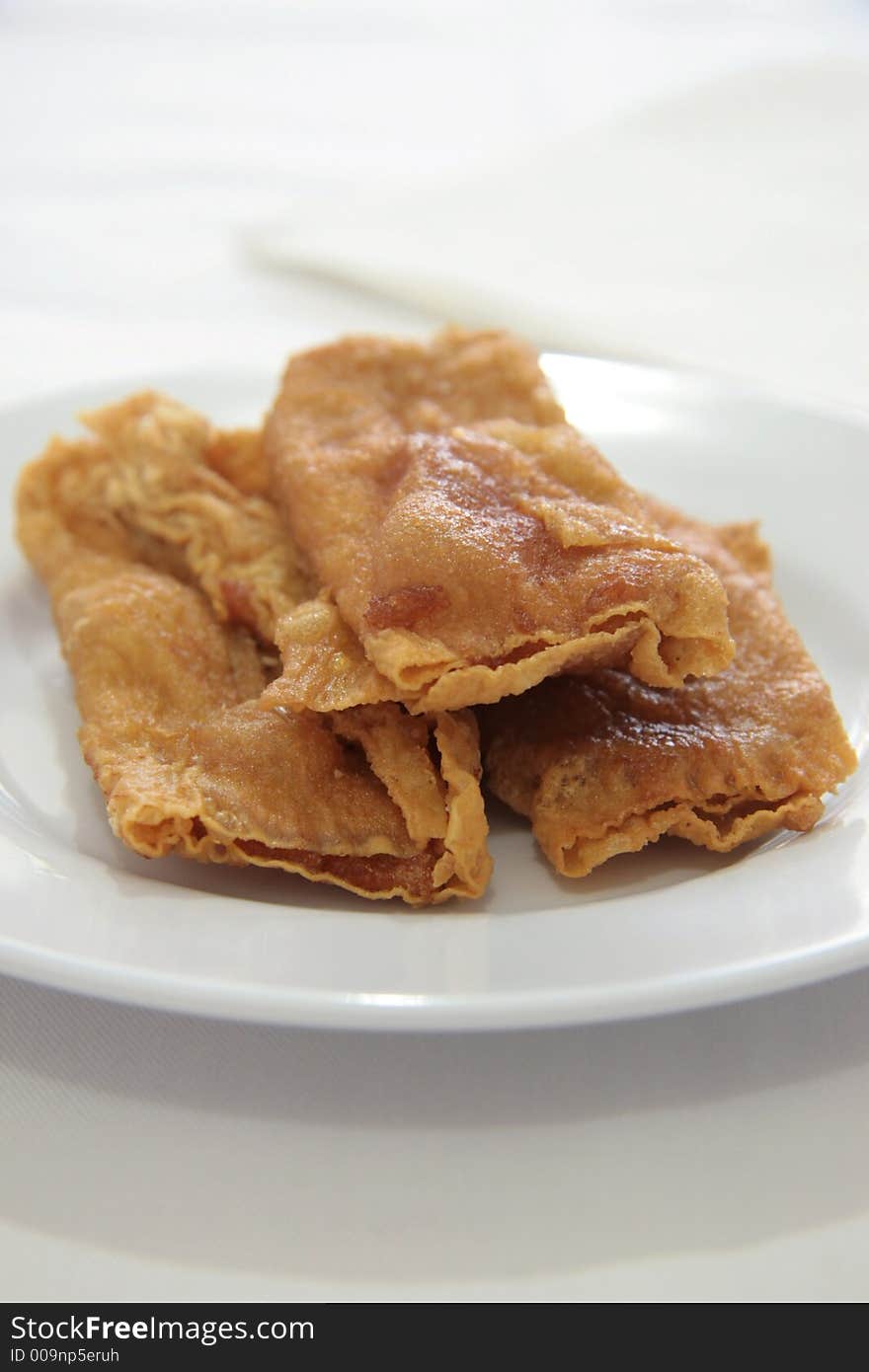 Deep fried flat spring rolls with boiled fish paste rolled in soy scum skin. Deep fried flat spring rolls with boiled fish paste rolled in soy scum skin