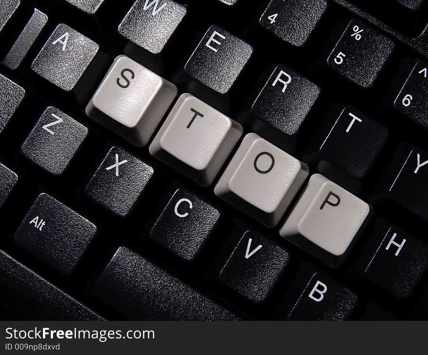 Black computer keyboard, with stop word